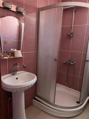 a bathroom with a shower and a sink at Ennis İnn Resort Hotel in Marmaraereglisi