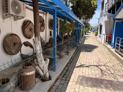 a building with a fence next to a street at Ennis İnn Resort Hotel in Marmaraereglisi