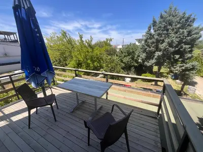 a patio with a table and chairs and an umbrella at Ennis İnn Resort Hotel in Marmaraereglisi