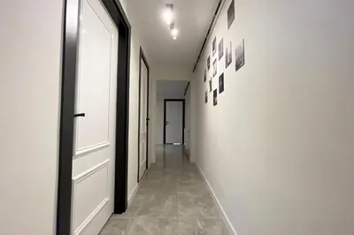 a hallway with a door and pictures on the wall at charming apt with fast WİFİ and AC near Nişantaşi and Taksim#5 in Istanbul