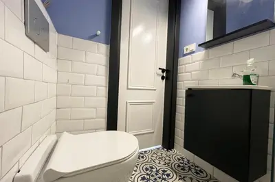 a bathroom with a toilet and a sink and a door at charming apt with fast WİFİ and AC near Nişantaşi and Taksim#5 in Istanbul