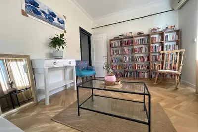 a living room with a table and some book shelves at cozy 2BR 2BATH with balcony near to nişantaşi and taksim #4 in Istanbul