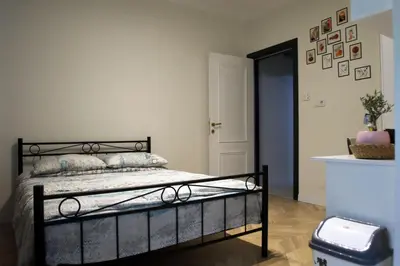 a bedroom with a black bed and a blue door at balcony 2BR apt with 2toilet and 2bath near to nişantaşi #3 in Istanbul