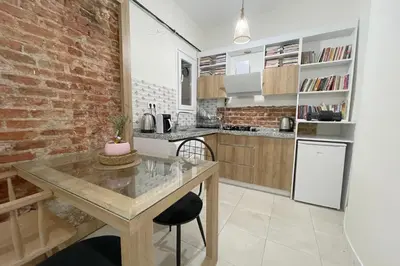 a kitchen with a table and a brick wall at balcony 2BR apt with 2toilet and 2bath near to nişantaşi #3 in Istanbul