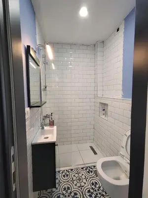 a white bathroom with a sink and a toilet at balcony 2BR apt with 2toilet and 2bath near to nişantaşi #3 in Istanbul
