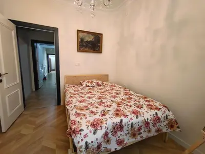 a bedroom with a bed with a floral bedspread at balcony 2BR apt near to nişantaşi #2 in Istanbul