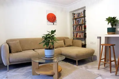 a living room with a couch and a table at baesment 2BR apt with 2toilet and 2bath 8min to metro #1 in Istanbul