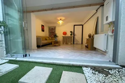 a living room with a glass door and a couch at baesment 2BR apt with 2toilet and 2bath 8min to metro #1 in Istanbul