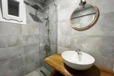a bathroom with a sink and a mirror on the wall at baesment 2BR apt with 2toilet and 2bath 8min to metro #1 in Istanbul