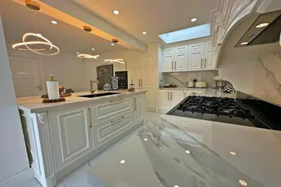 a kitchen with white cabinets and a stove top oven at Cloud Nine by Alara - Luxury Private Pool and Garden Villa in Beylikduzu