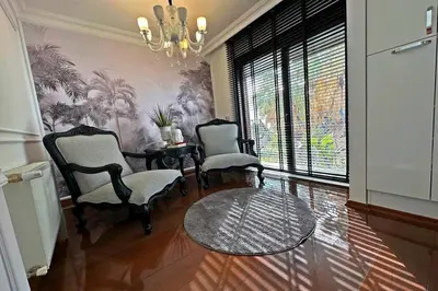 a living room with two chairs and a table and a chandelier at Cloud Nine by Alara - Luxury Private Pool and Garden Villa in Beylikduzu