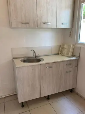 a kitchen counter with a sink and a phone at Kalemi Pansiyon in Marmara