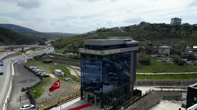 a building with a sign on it next to a highway at Hmz Premium Konaklama Çekmeköy in Çekmeköy