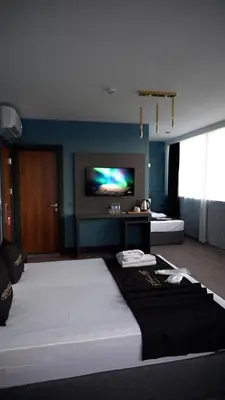 a bedroom with a large bed and a flat screen tv at Hmz Premium Konaklama Çekmeköy in Çekmeköy