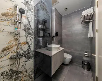 a bathroom with a sink and a shower at Airport Waves Hotel in Arnavutköy