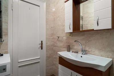 a bathroom with a sink and a mirror at Elegant 2BR Haven with Magnificent Bosphorus View in Istanbul