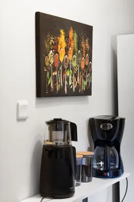 a coffee maker on a shelf with a picture on the wall at Fully Equipped & Modern Designed Spectacular 3BR in Istanbul