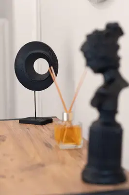 a black coil sitting on top of a wooden table with a black chess at Fully Equipped & Modern Designed Spectacular 3BR in Istanbul