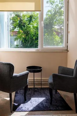 a room with two chairs and a table and a window at Fully Equipped & Modern Designed Spectacular 3BR in Istanbul