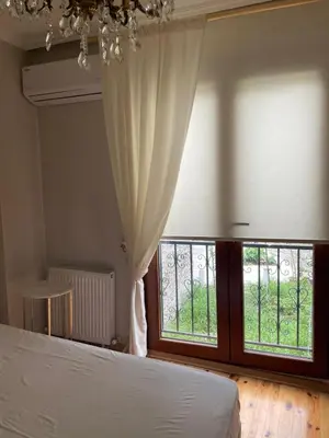 a bedroom with a bed and a large window at Pink Home 4 in Istanbul