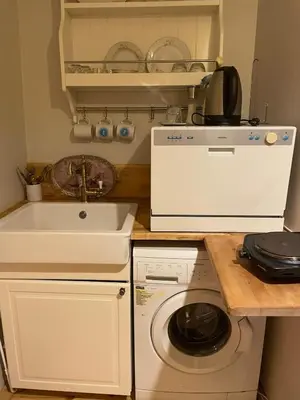 a kitchen with a washing machine and a sink at Pink Home 4 in Istanbul
