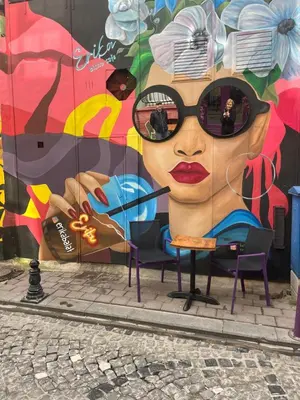 a mural of a woman with sunglasses on her face at Pink Home 4 in Istanbul