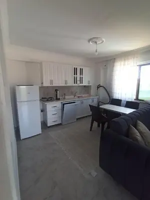 a kitchen with a refrigerator and a table and a couch at Kandıra villam in Duraklı