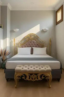 a bedroom with a king sized bed with a gold frame at PeraHomes in Istanbul