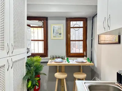 a kitchen with a small table and two stools at PeraHomes in Istanbul