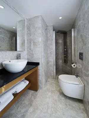 a bathroom with a sink and a toilet and a tub at Milport Hotel Levent Istanbul in Istanbul