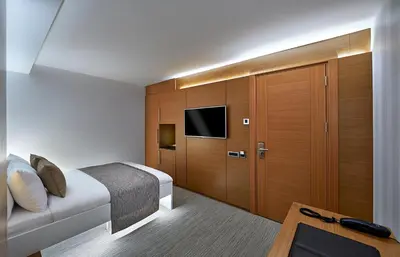 a bedroom with a bed and a tv and a cabinet at Milport Hotel Levent Istanbul in Istanbul
