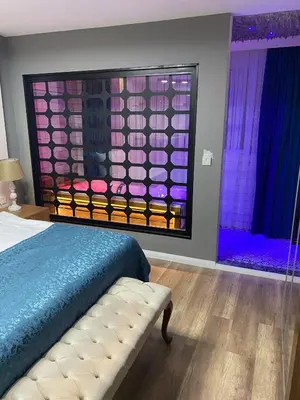 a bedroom with a bed and a window with purple lights at Taksim Yazıcı Residence in Istanbul
