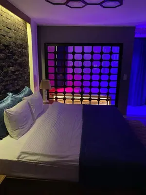 a bedroom with a bed with purple lights on it at Taksim Yazıcı Residence in Istanbul