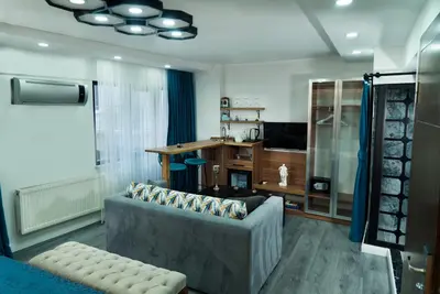 a living room with a couch and a television at Taksim Yazıcı Residence in Istanbul