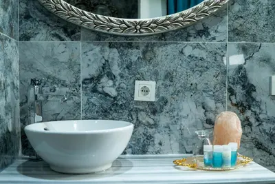 a bathroom with a white sink and a mirror at Taksim Yazıcı Residence in Istanbul