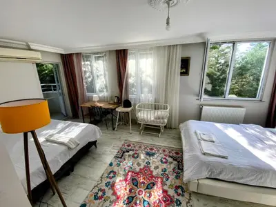 a bedroom with two beds and a table and chairs at forest villa, breakfast hotel, 6 minutes from Istanbul airport in Arnavutköy