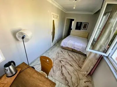 a bedroom with a bed and a desk and a window at forest villa, breakfast hotel, 6 minutes from Istanbul airport in Arnavutköy