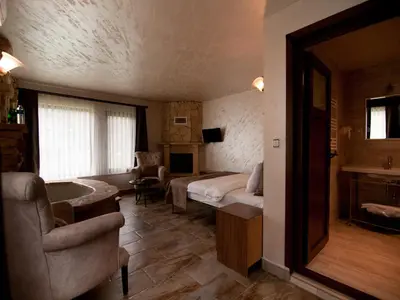 a bedroom with a bed and a couch and a chair at Gizemli Nehir Bungalov Otel in Agva