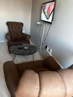 a living room with a couch and a chair and a table at Butik Apart in Tekirdag