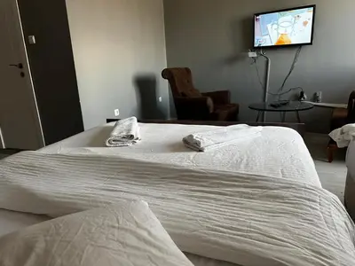 a white bed with two towels on top of it at Butik Apart in Tekirdag