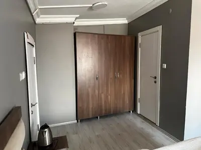 a room with a closet and a wooden door at Butik Apart in Tekirdag
