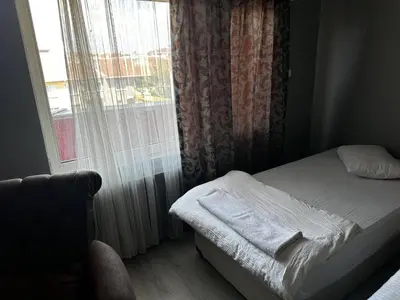 a small bedroom with a bed and a window at Butik Apart in Tekirdag