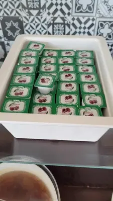 a white tray filled with green and pink cupcakes at Yağcı Hotel Erdek in Erdek