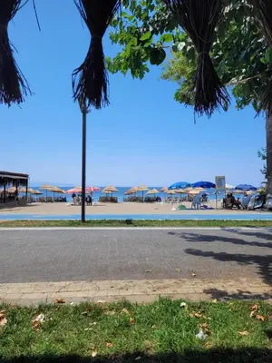 a view of a beach with umbrellas and a street at Yağcı Hotel Erdek in Erdek