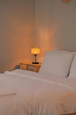 a bedroom with a bed with a lamp on a night stand at Kiwii Sapanca in Sapanca