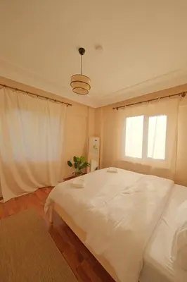 a bedroom with a large white bed and a window at Kiwii Sapanca in Sapanca