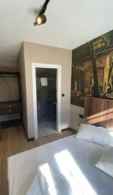 a bedroom with a bed and a painting on the wall at Nest Ortaköy in Istanbul