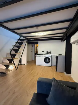 a living room with a couch and a staircase at Nest Ortaköy in Istanbul