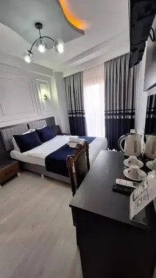 a hotel room with a bed and a desk with a desk at RAMOS İSTANBUL OLD CİTY CENTEr in Istanbul