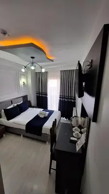 a bedroom with a bed and a table in it at RAMOS İSTANBUL OLD CİTY CENTEr in Istanbul